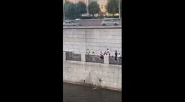 Passersby lower fence panel to rescue swimmer stranded in canal