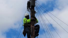 Telecoms Communications Engineer working up telegraph pole