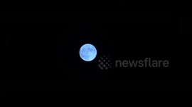 Stunning blue supermoon illuminated night sky above Los Angeles