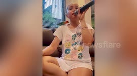 Chirpy pet bird joins woman singing karaoke songs