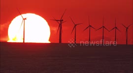Stunning Omega sunrise behind wind farm in Kent, UK