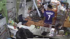 Motorcycle rider with toddler in his lap accidentally crashes through glass shopfront