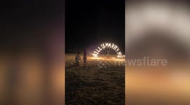 Boyfriend makes heartwarming proposal on beach with fire spinners