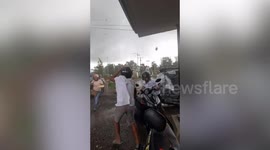 Motorists take shelter in building as tornado hits town in the Philippines