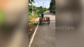 Pet French bulldog goes for a ride in trailer pulled by schoolboy