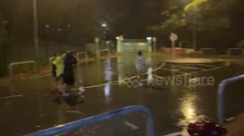 Strong winds by the side of a building create mini tornado as Super-Typhoon Saola makes landfall