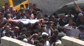 Mourners carry the body of Palestinian AbdulRahim Fayez Ghannam during his funeral in the village of Aqaba in the occupied West Bank