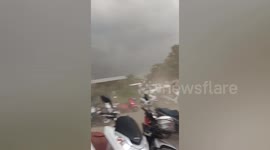 Strong wind whips up dust at market in Thailand