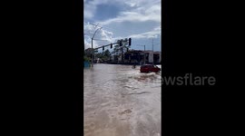 US: Man Cycles Through Flooded Road In Las Vegas