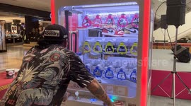 Claw grabber game with Nike sports shoes inside entertains visitors to 'sneaker festival'