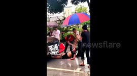 Chinese residents heroically rescue boy trapped under car from wet step slide