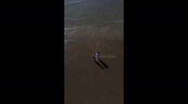 Playing in the sea at Westward Ho. 2 children playing on holiday.