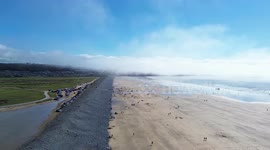 Westward Ho beach as a sea mist is approaching. The drone goes under, through and over the mist.