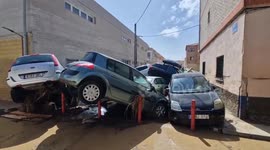 Cars heaped on top of each other as Toledo resident inspects Storm Dana damage