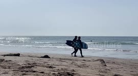 Surfers in Cornwall hit the beaches as Uk hit with surprise heatwave