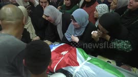Mourners carry the body of Palestinian Ayed Abu Harb, a 21-year-old who was shot dead by Israeli forces during a raid in the Nur Shams camp for Palestinian refugees