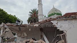 Locals and officials inspect debris of building collapse that killed 4 in northern India