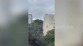 Painters dangle dangerously from side of building in India