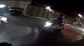 Motorcycle rider accidentally hits stray dog that suddenly dashes across road