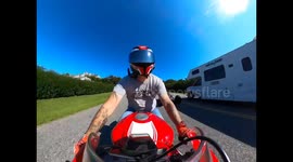 Motorcyclist Hangs On When Hit