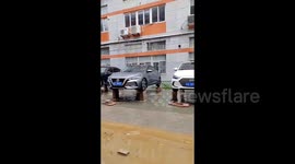 Smart owners elevate cars on bricks to beat flash floods brought by typhoon Haikui