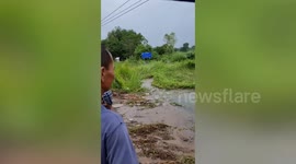 Raging flood washes away fields amid heavy rain in Thailand
