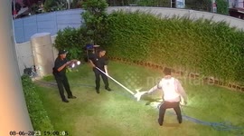 Security guards catch wild monitor lizard in family's garden