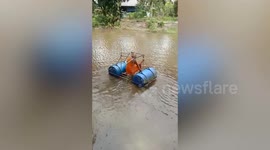 Playful Buddhist monk's makeshift raft capsizes while crossing river