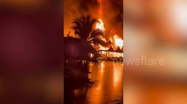 Huge fire rips through market in Thailand sending locals jumping into water