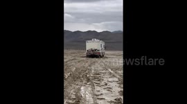 US: Footage Of Vehicles Stuck In Mud Attempting To Leave Burning Man