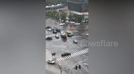 Drivers baffled by cleaning truck spraying water on flooded road in China