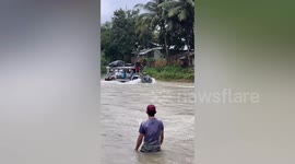 Buses drive through raging river amid floods and rain in the Philippines