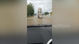 Overload pickup drives through flooded road in Thailand