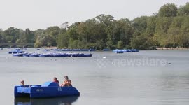 People enjoying the warm weather in Hyde Park in central London, UK