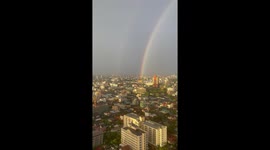 Beautiful double rainbow forms over Bangkok at sunset