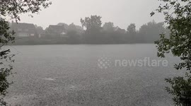 Very heavy rain falling on a lake in Lincoln England during a storm