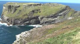 A view of Merlins Cave on a windy day at tintagel headland, so pretty the colours of blue against the stone.