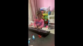 Adorable toddler playing the keyboard