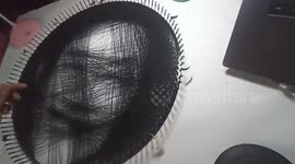 Artist makes pictures from string threaded across electric fan cover