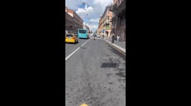 Two daredevils navigate St. Petersburg traffic on tandem one-wheel scooter