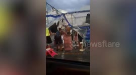 Tropical storm batters market as stallholders secure their tables