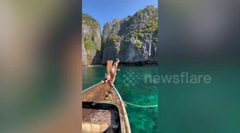 Backpacker's picturesque holiday diving video fails when she slips on boat