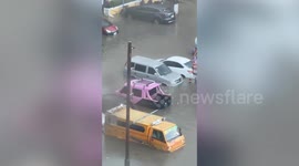Cars submerged in heavily flooded carpark during monsoon rain in the Philippines