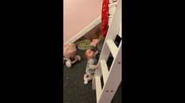 Toddler with a wicked sense of humor laughs when his sister falls down a slide