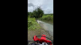 Off-road motorcycle rider sinks while trying to cross through stream