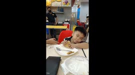 Fried chicken is life! Boy loves his fast food meal... even when falling asleep