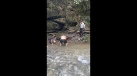 Baffled tourist tries and fails to douse flames that keeps on erupting at the edge of river in China