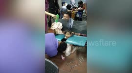Girl with head stuck between two waiting room chairs rescued in Thailand