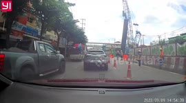 Huge metal pole drops from crane into flow of cars below
