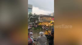 Locals cheers as bus powers through flooded road in the Philippines